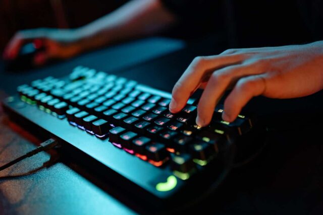 Photo of a Person's Hand Playing on a Black Keyboard