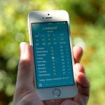 person holding turned on silver iPhone 5s displaying liverpool